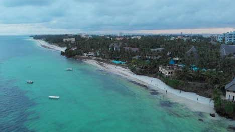 Mombasa-beach-during-an-overcast-sunset,-with-resorts-in-the-background