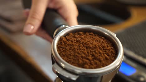 SLOWMO---Fresh-ground-coffee-beans-in-portafilter---close-up