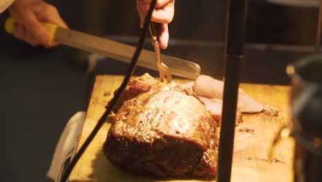 Chef-slicing-roast-beef-on-a-cutting-board