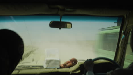 Dusty-roads-of-Serengeti-Valley-national-park,-with-cars-passing,-Tanzania