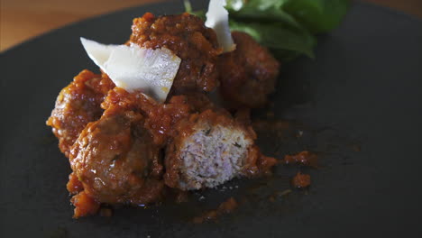 Close-Up-of-a-Man-eating-Meatballs-in-Tomato-Sauce,-well-presented-dish-and-fine-dining-experience