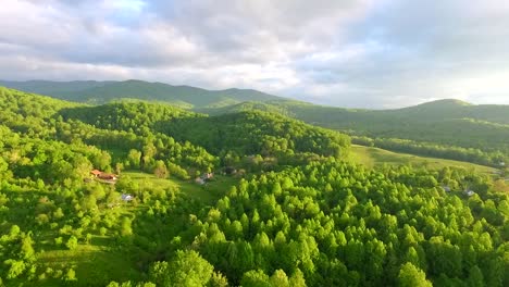 Aerial-mountain-sunrise-at-dawn-golden-light-and-green-hills-and-blue-sky-in-the-Shenandoah-Valley,-part-of-the-blue-ridge-mountain-chain-in-Virginia