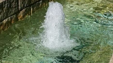 extreme-close-up-of-a-water-fountain-sparkling-and-glistening-and-splashing-slow-motion