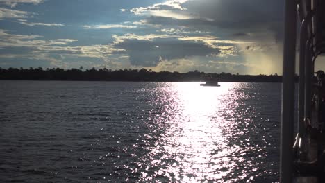 Wide-shot-of-a-Boat-Safari-on-Zambian-River,-during-Sunset