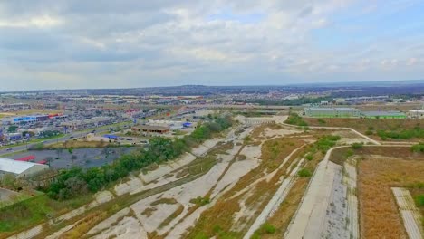 Drone-footage-showing-flood-plain-area-and-stores-with-high-way-in-the-distance