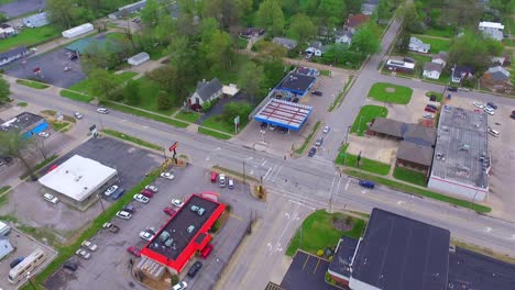 Aerial-view-of-an-stoplight-intersection-with-cars-traveling-through-during-the-daytime
