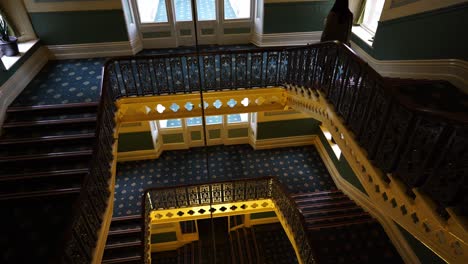 A-young-women-walk-down-the-stairs-at-the-luxurious-victorian-hotel-in-the-rural-area-of-Buxton