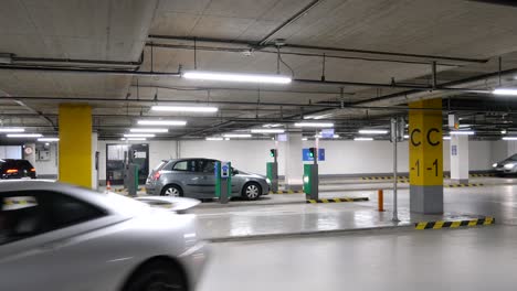 Driving-cars-in-an-underground-garage-in-a-European-shopping-mall-with-entry-gate