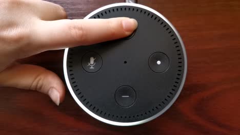 Close-up-video-of-a-girl-pressing-the-volume-up-button-on-the-Alexa-Echo-Dot-Amazon-device