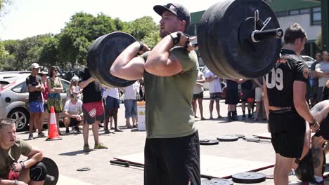 Adult-Male-Athlete-Performing-Multiple-Front-Squats-at-a-Cross-Fit-Competition