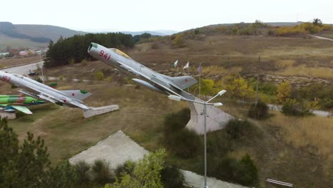 Aerial-arc-footage-of-military-airplanes-outdoor-museum-exhibition
