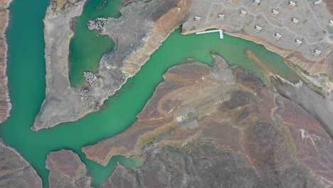 Aerial-view-of-a-lake-surrounded-by-mountains-near-Dubai-in-Hatta,-United-Arab-Emirates