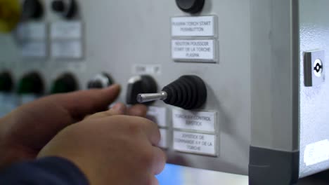 Man-operates-a-control-panel-at-the-factory