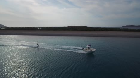 Aerial-drone-shot-of-a-person-skiing-in-the-Sea-of-Cortez