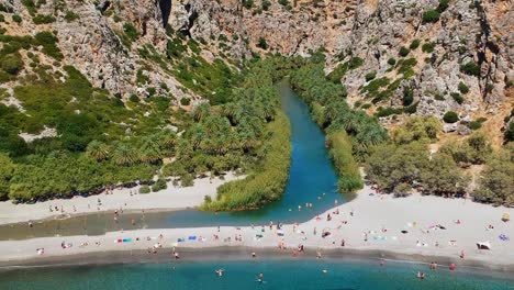 Aerial-footage-of-the-heavenly,-serene-river-and-lagoon-known-as-Preveli-beach