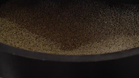 Fresh-coffee-beans-pumped-into-a-coffee-roaster-machine