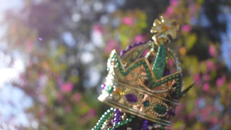 Outdoor-Mardi-Gras-beads-and-crown-on-light-post-in-sunshine