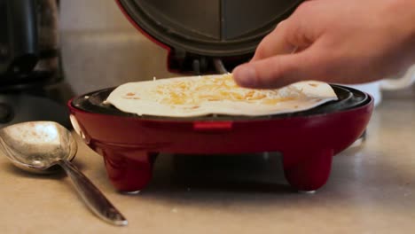 1080p-still-shot-of-cheese-being-sprinkled-onto-cooking-quesadilla