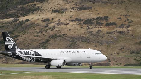 SLOWMO---Commercial-plane-departing-from-Queenstown-Airport,-New-Zealand-with-mountains-in-background