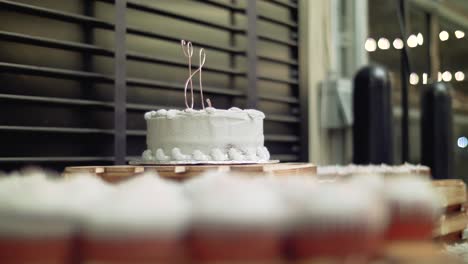 Wedding-Dessert-Table,-Rack-Focus-Camera-Slide-From-Cupcakes-To-Monogram-Cake-Topper