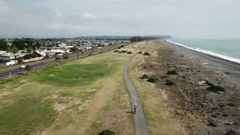 Aerial-shot,-tracking-on-a-person-cycling-on-the-bike-track-in-napier,-new-zealand