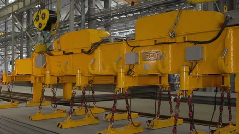 Closeup-of-a-heavy-magnet-lifting-machine-lifting-a-plate-of-steel-on-a-construction-site