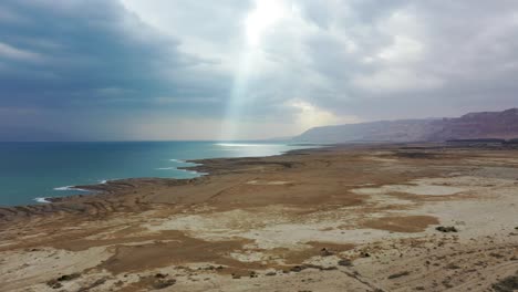 Dramatic-sun-ray-light-over-the-Deadsea-Cost-line,-cloudy-sky,-holy-view