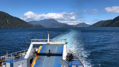 View-of-the-back-of-a-Ferry-sailing-trough-mountains,-south-of-Chile