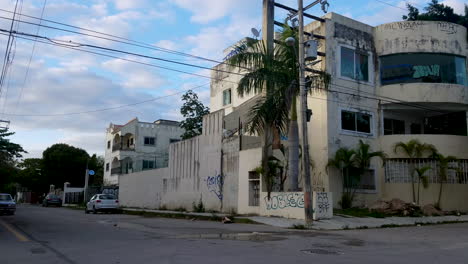 Two-teenagers-are-passing-by-and-abandoned-building-in-downtown-Playa-Del-Carmen
