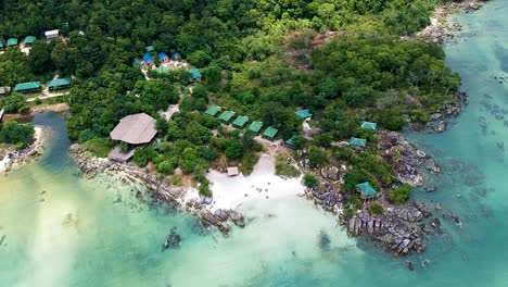 Aerial-establishing-shot-of-private-beach-resort-at-island-paradise-in-Koh-Rong-Sanloem,-Cambodia