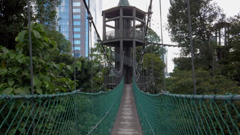 Steadicam-Shot-of-a-hanging-suspension-bridge-at-the-Canopy-Walk-in-Kuala-Lumpur,-Malaysia