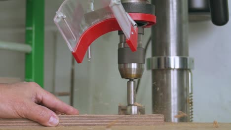Carpenter-using-a-Pillar-drill-to-make-a-hole-into-a-block-of-wood-at-100fps-slow-motion