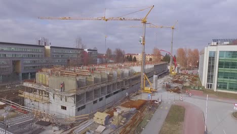 slow-rise-with-a-drone-over-construction-site-with-cranes