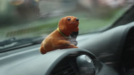 Sliding-B-Roll-of-Puppy-Doll-On-the-Car's-Dashboard