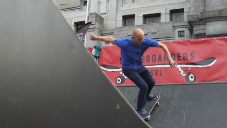 Skater-performs-a-cool-sweeper-trick-on-a-wooden-ramp