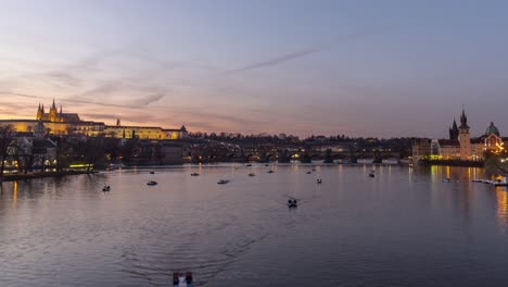 Timelapse-of-paddle-boats-on-Vltava-river-in-Prague-with-castle-and-Charles-Bridge-in-the-background,-4K-static-view