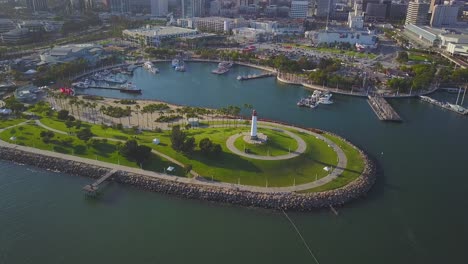 Aerial-drone-footage-of-Light-house-in-the-Long-Beach-Harbor-showing-downtown-buildings