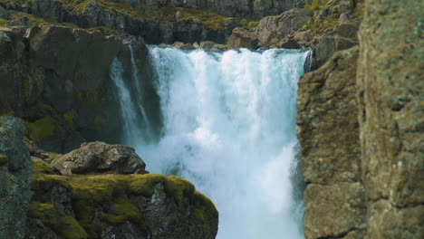 Sunny-light-on-Fossardalur-waterfall,-Eastern-Iceland