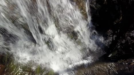 Aerial-approach-to-the-crest-of-a-mountain-waterfall-near-Blowing-Rock,-North-Carolina