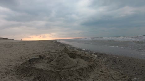 Sand-Castle-on-the-ocean-at-the-sunset-on-a-windy-cold-day