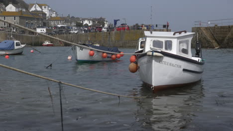 Frontal-view-of-Cornish-boats-moored-within-Mousehole-harbour-walls
