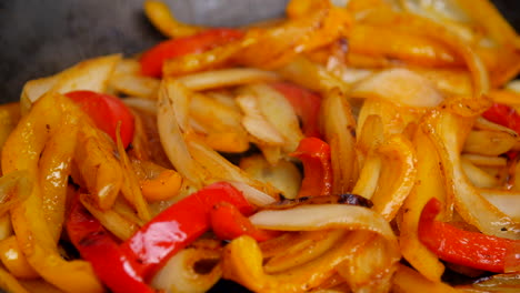 Bell-peppers-and-onions-simmer-in-a-pan