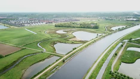 Aerial-footage-of-the-big-canal,-river,-and-view-ponds-in-the-Netherlands