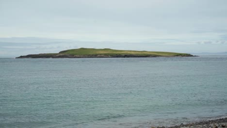 Solitary-island-with-waves-lapping-up-on-shore
