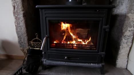 Wood-stove-has-bright-glow-of-fire-after-being-lit-and-blazing-in-the-burner