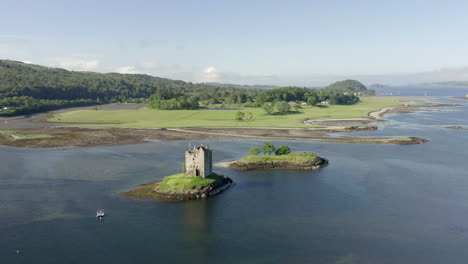 An-aerial,-high-view-of-Castle-Stalker-on-Loch-Laich-on-a-sunny-morning