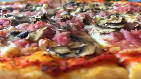 Spinning-pizza-with-burnt-crust-in-slow-motion-close-up