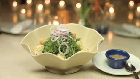 Panning-Shot-Of-A-Salad-In-A-Bowl-For-A-Candle-Light-Dinner-4K