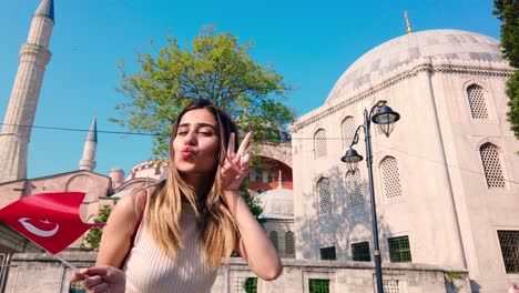 Slow-motion:Beautiful-young-girls-waves-Turkish-flag-in-front-of-an-ancient-building-in-İstanbul,Turkey,Travel-concept