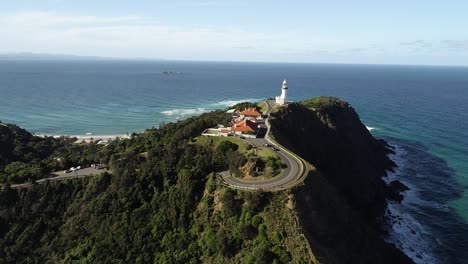 Aerial-footage-of-a-lighthouse-at-sunset-on-top-of-a-hill